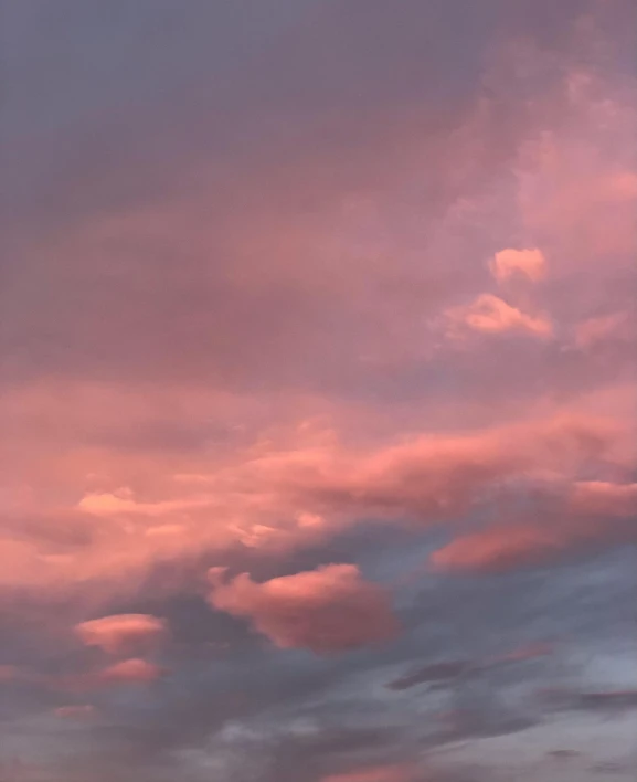 clouds are lit up in the distance as a light shines