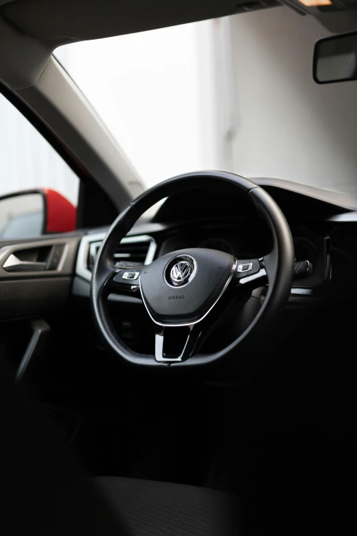 the dashboard and dash of a car with two red seats