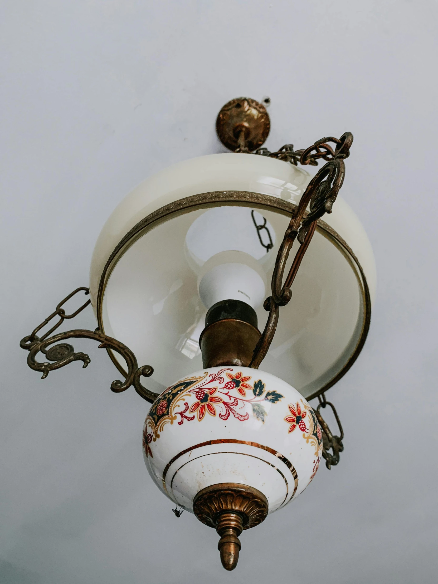 a white light with red flowers on a chain