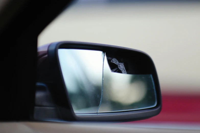 a person's hand is shown with a rear view mirror