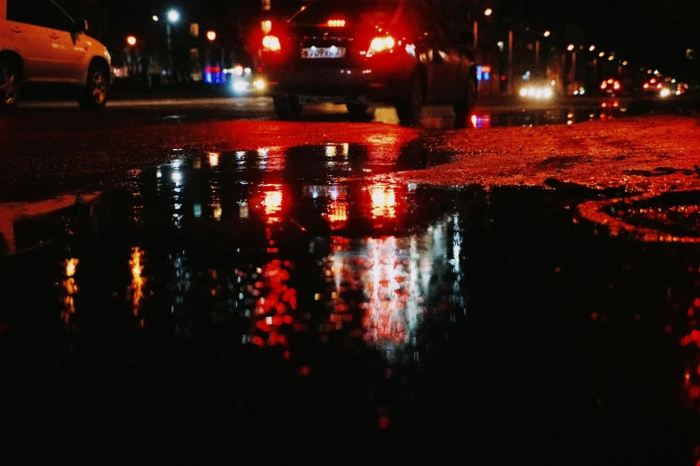 a night time scene with rain and traffic lights