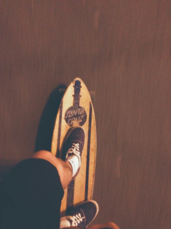 the legs and feet of someone riding a skateboard