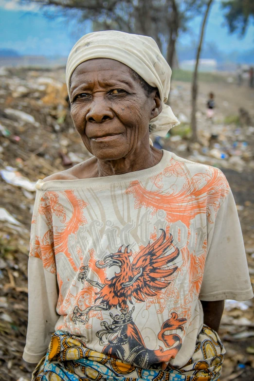 a woman standing next to some trash on the ground