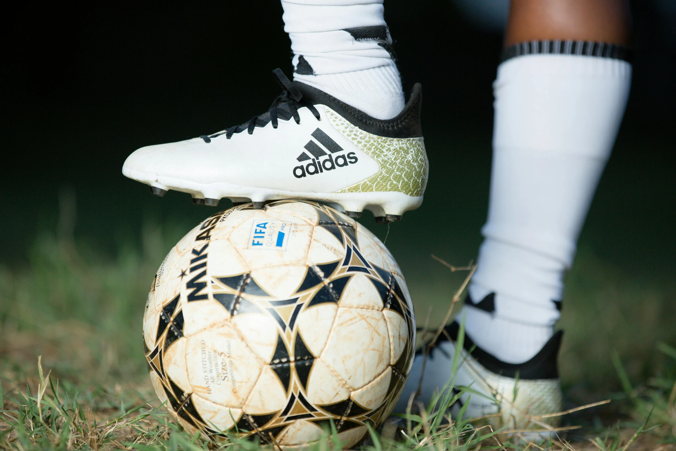 a soccer player is standing on top of a ball