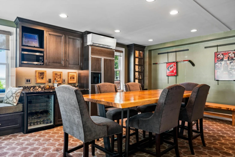 a dining room table with gray chairs in the middle