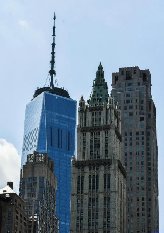 two tall buildings in the city with a very pointed roof