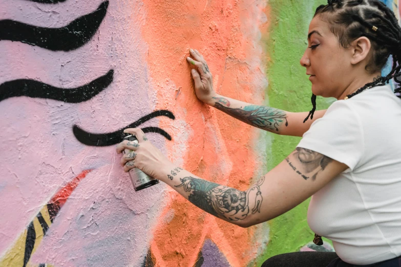 a woman with ids painting a wall