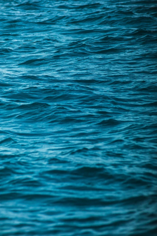 a man is paddling a jet ski across blue water