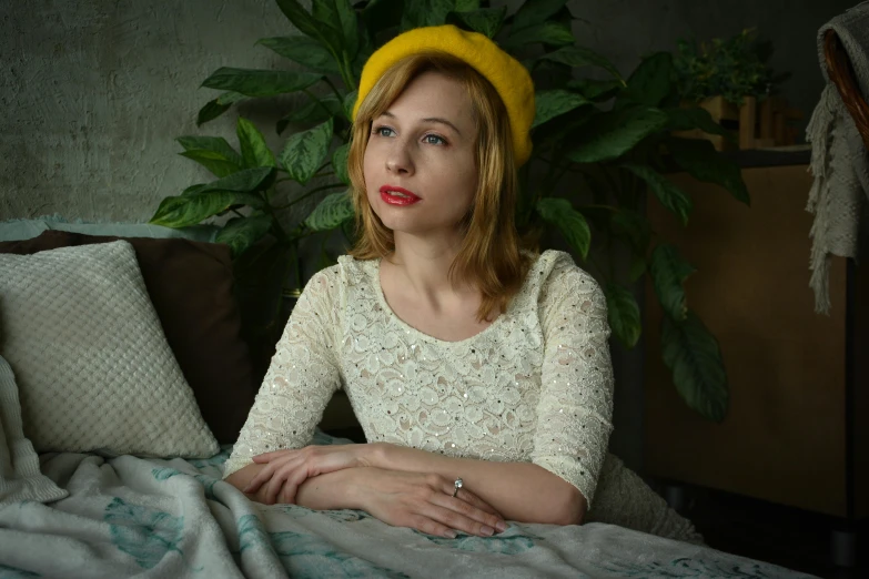 a woman with red lipstick sitting on top of a bed