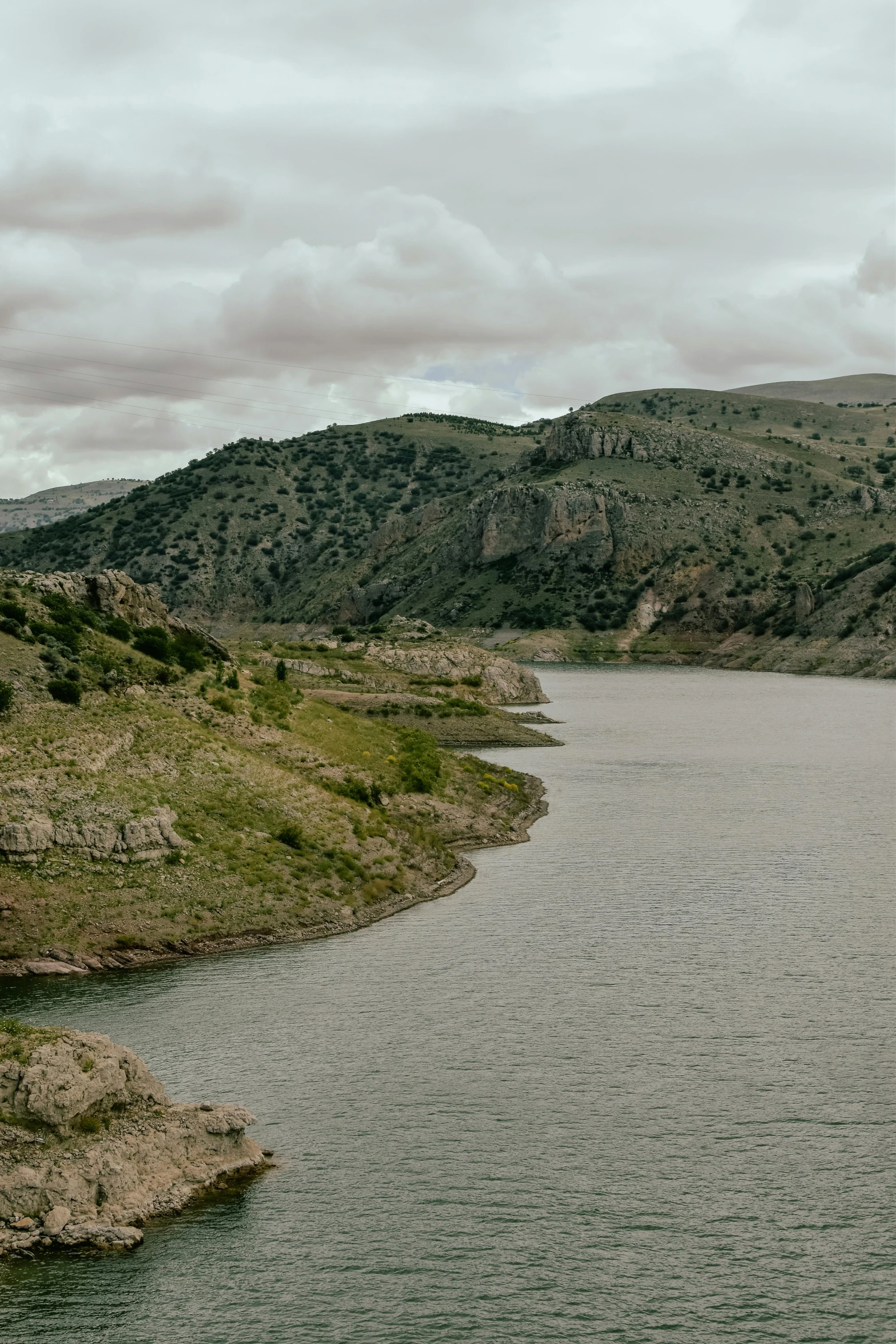 a body of water with hills in the background