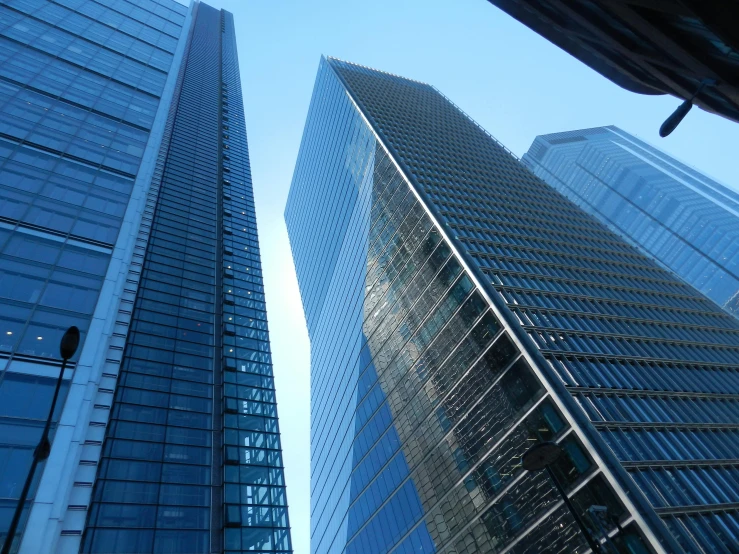 two tall buildings with a sky background
