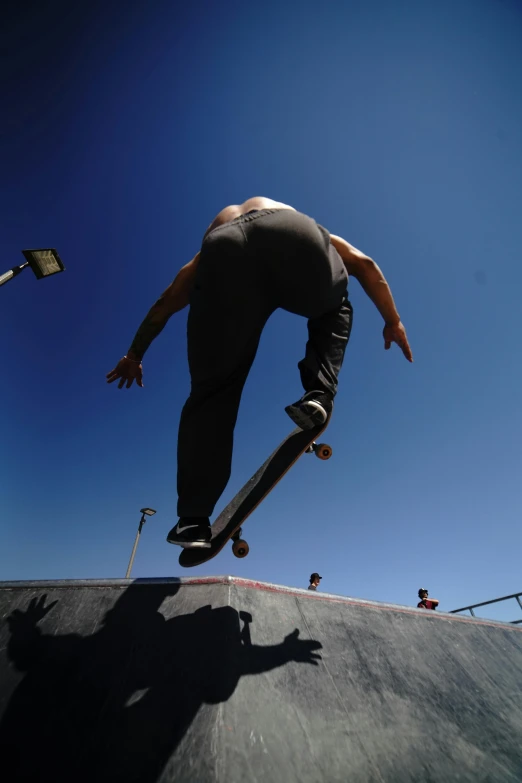 a man on a skateboard does a trick on the ramp