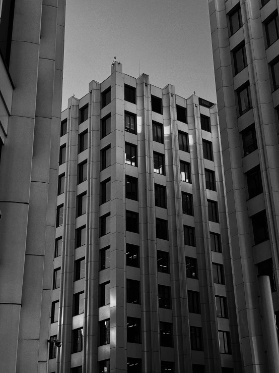 two large buildings with multiple windows and no lights