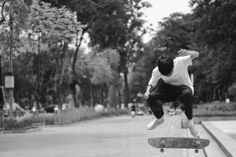 this boy does a flip on his skateboard on the edge of a bridge