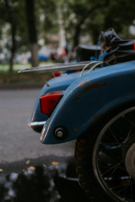 a blue motorcycle sitting on the street during the day