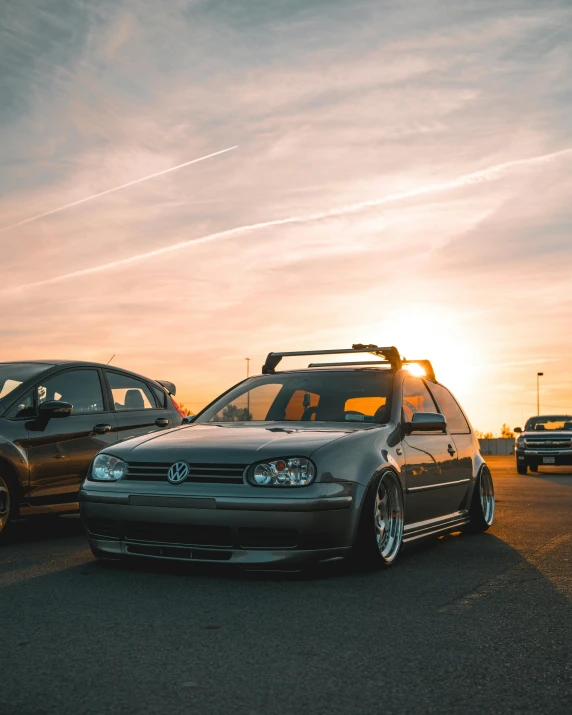 two cars are parked side by side on the road