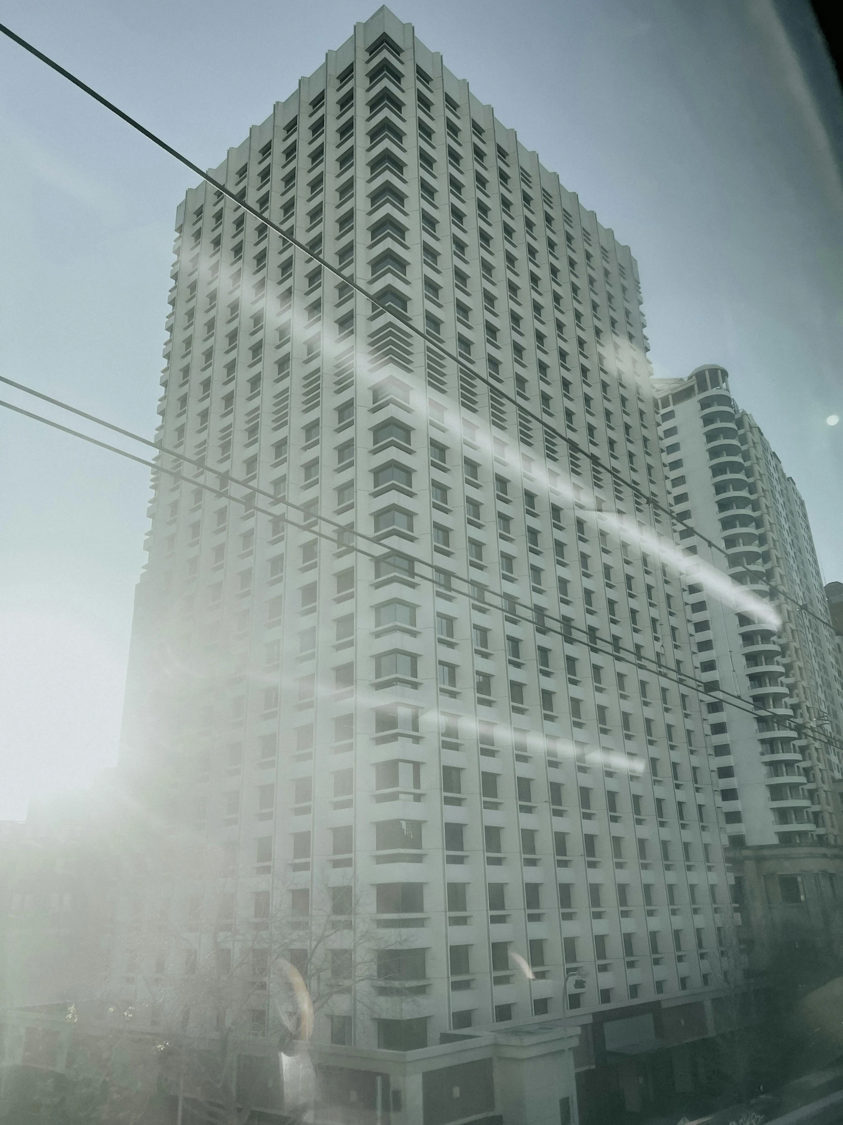 a very tall building next to a few cars