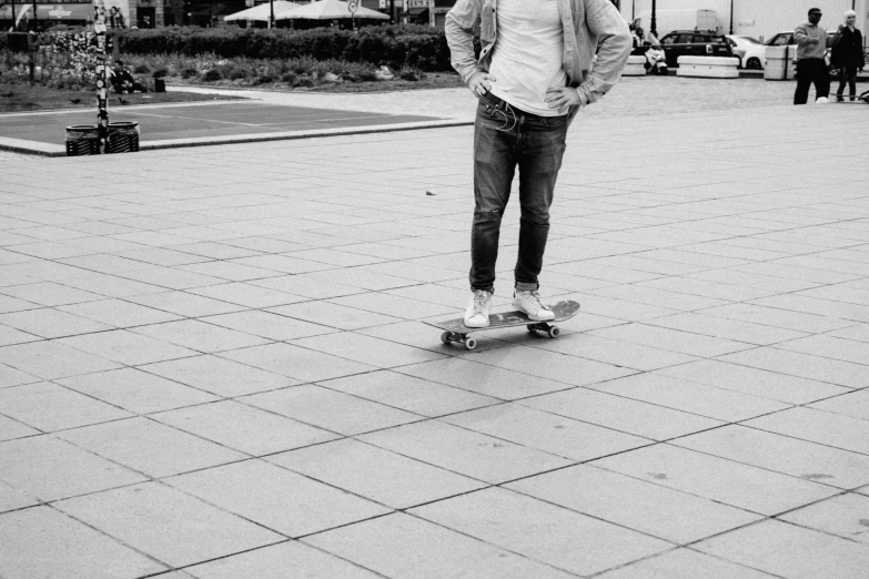 a man standing on a skateboard while staring off
