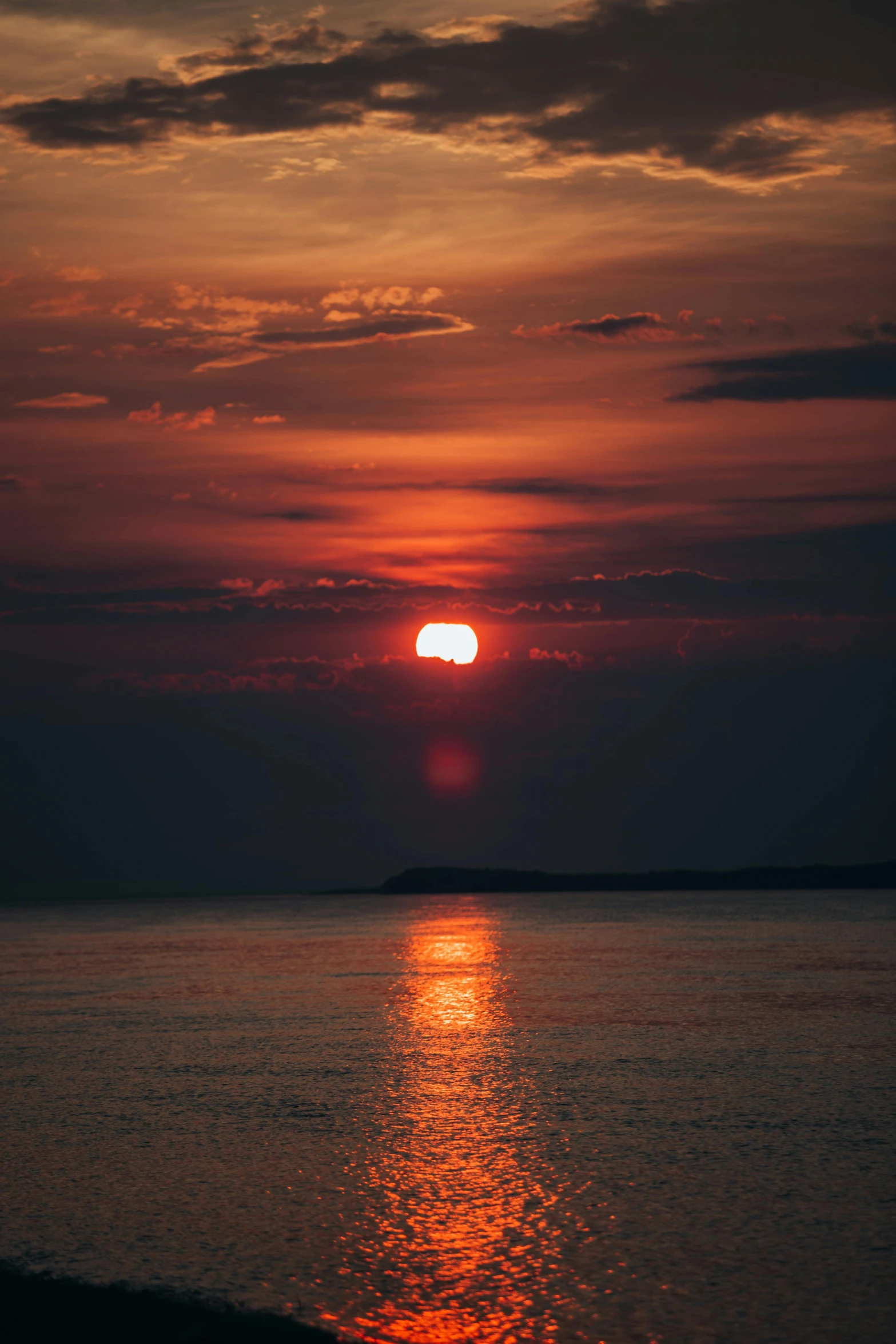 the sun is shining brightly on the water at sunset