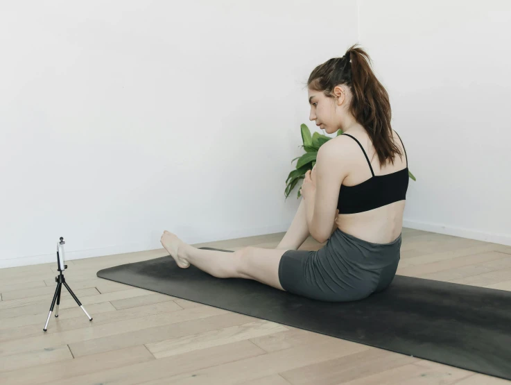 young woman doing yoga in a studio space