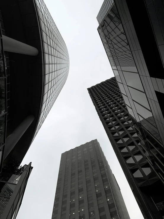 two large buildings with metal windows are seen from the ground