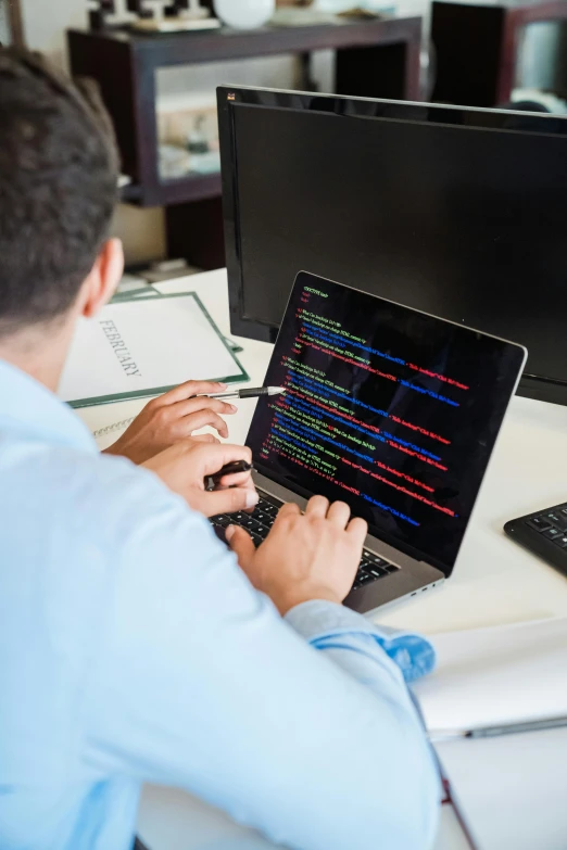 man working on computer program using different programming programs