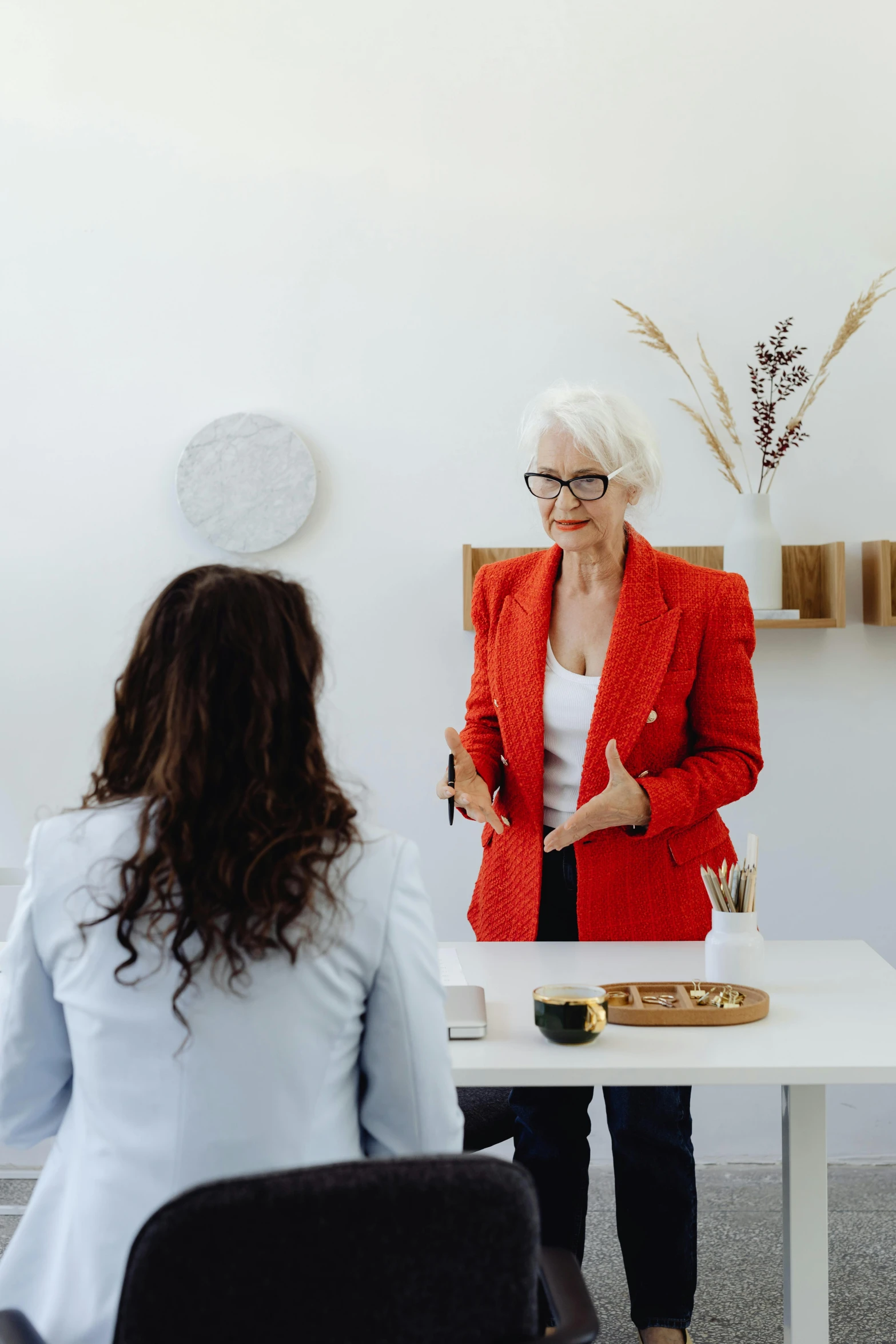 two women who are sitting down having conversation