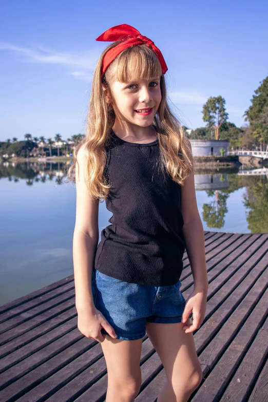 a  standing on a wooden pier next to water