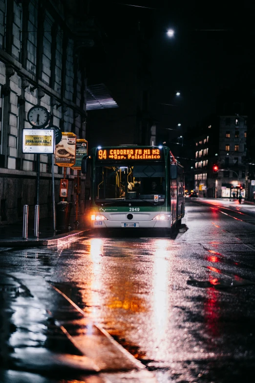 a bus on a street with buildings and rain