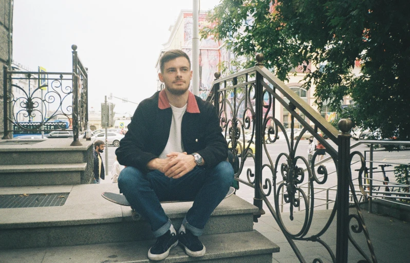 a man sitting on the steps of a building