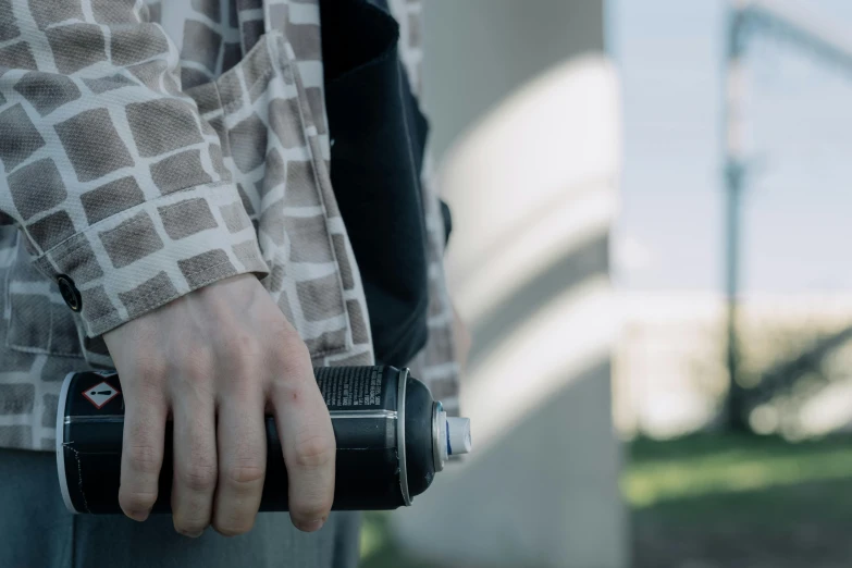 a person holding a camera in their left hand