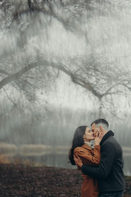 the man is giving his woman some kissing