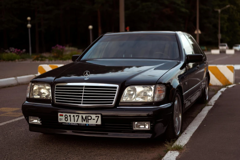 a black mercedes benz benz s - class in a parking lot