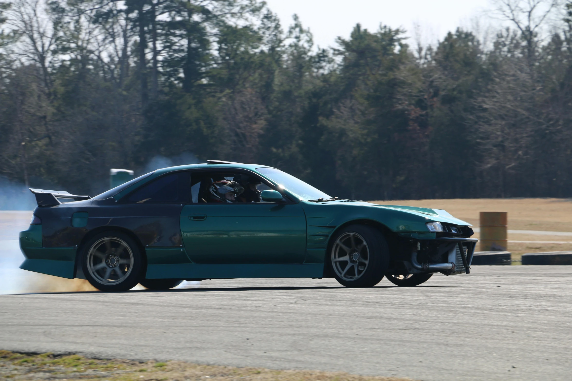 a blue sports car that is smoking a cigarette