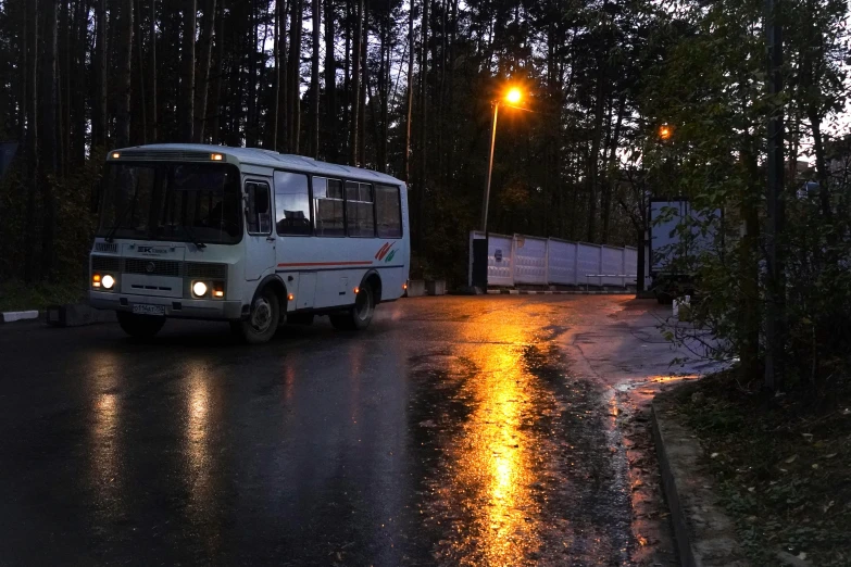 the bus drives down the street at night