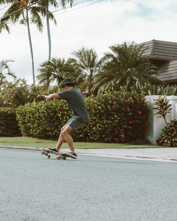 the skateboarder is riding in the street on his skate board