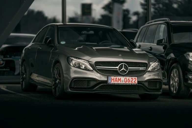 two mercedess are parked next to each other on the street