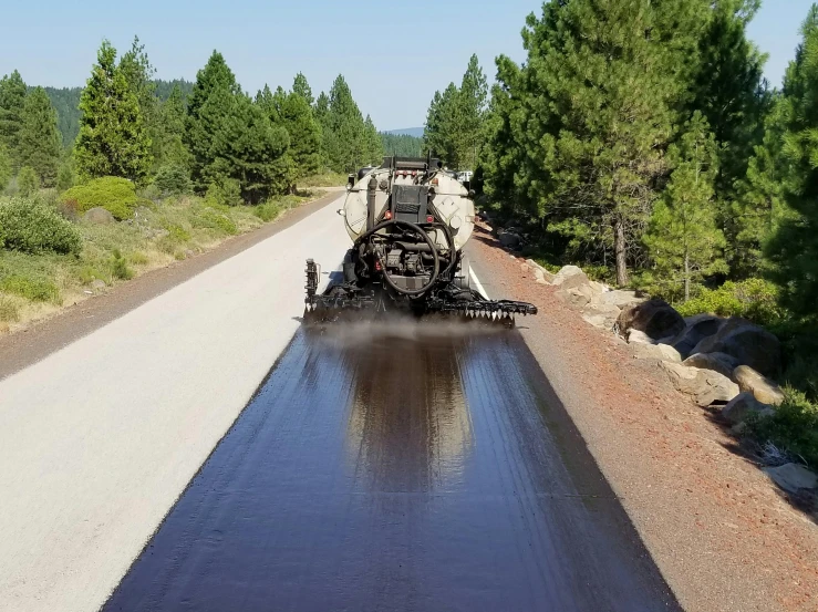 a train pulling a heavy load across a road