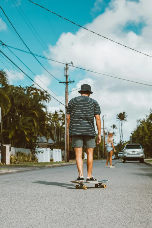 the man in the short shorts is skateboarding down the street