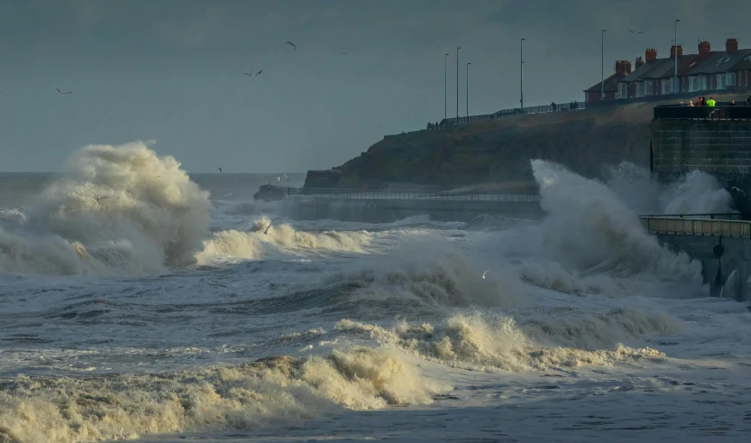 waves crashing into the rocks on a stormy beach