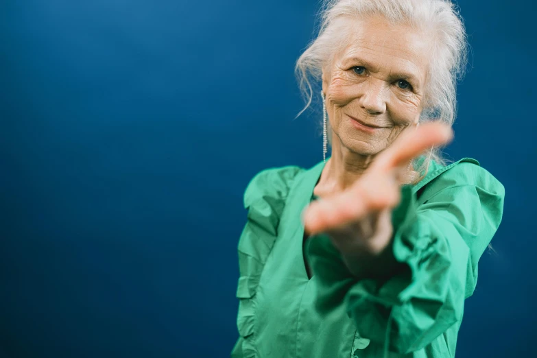 an older woman with a finger up in front of her