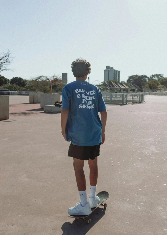 a young man stands on his skateboard