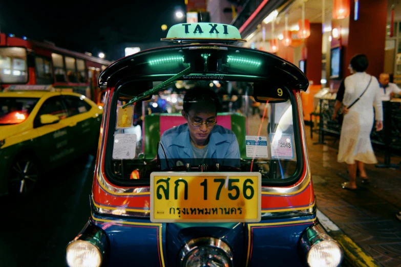 a taxi is stopped in front of a yellow taxi cab