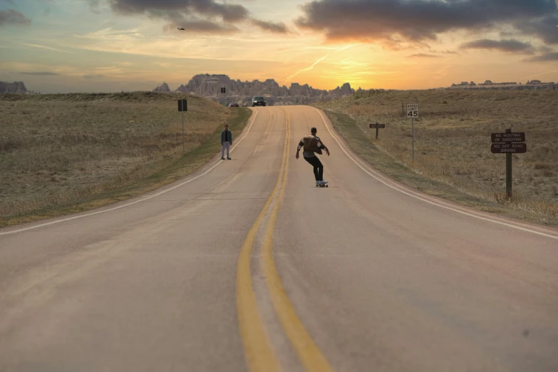 a person is skateboarding down the empty road