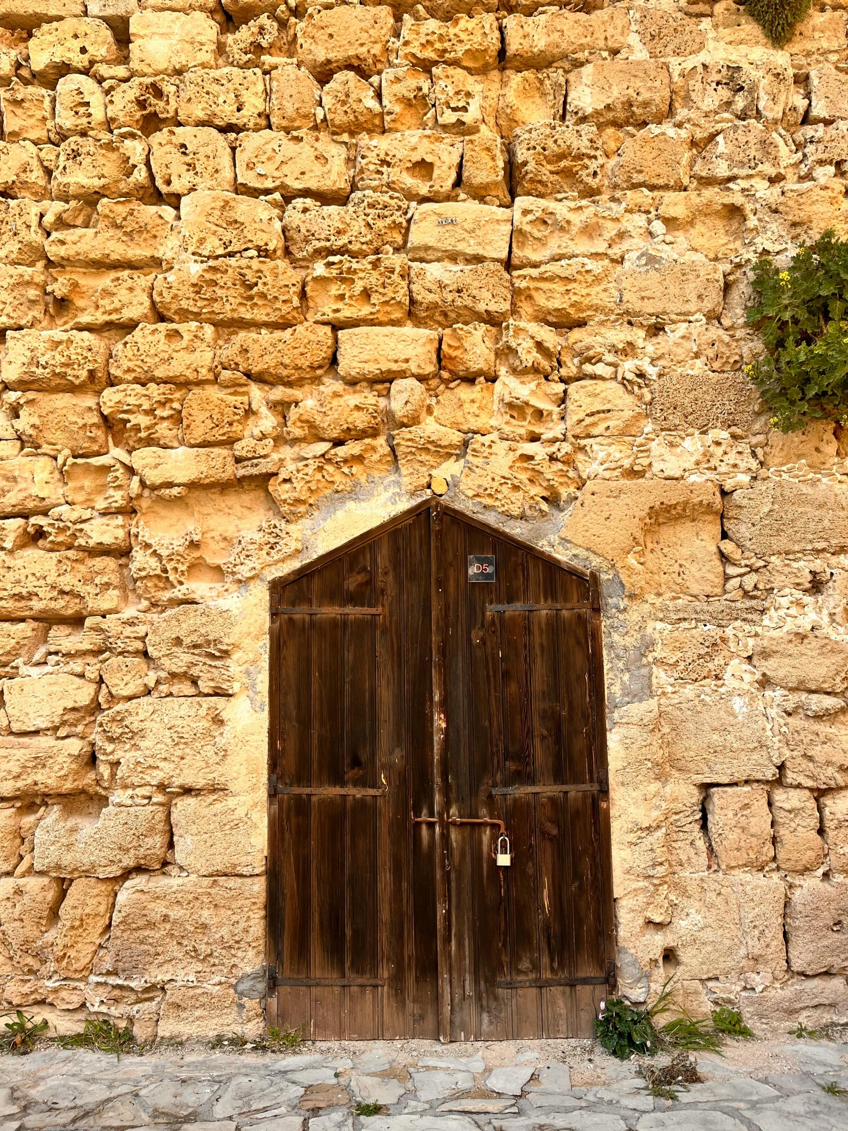 two large doors and an open doorway in the side of a building