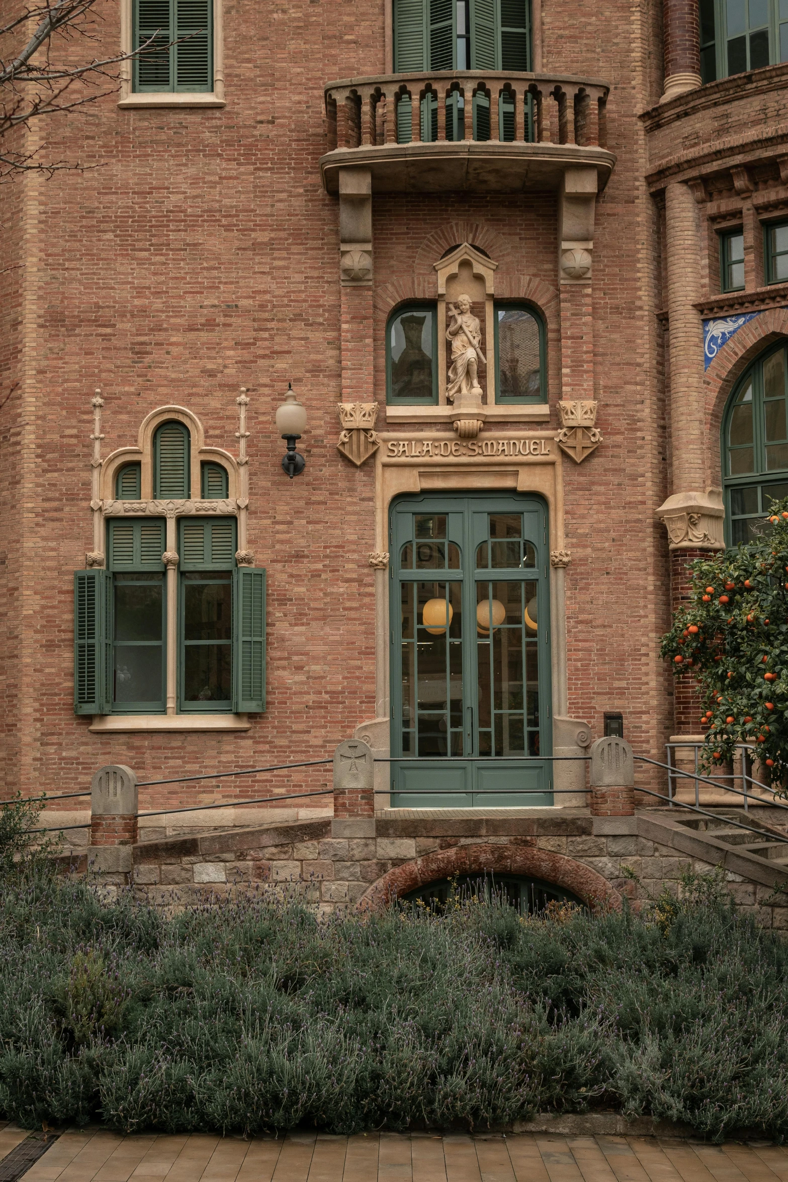 an old building that has green shutters and balconies on the windows