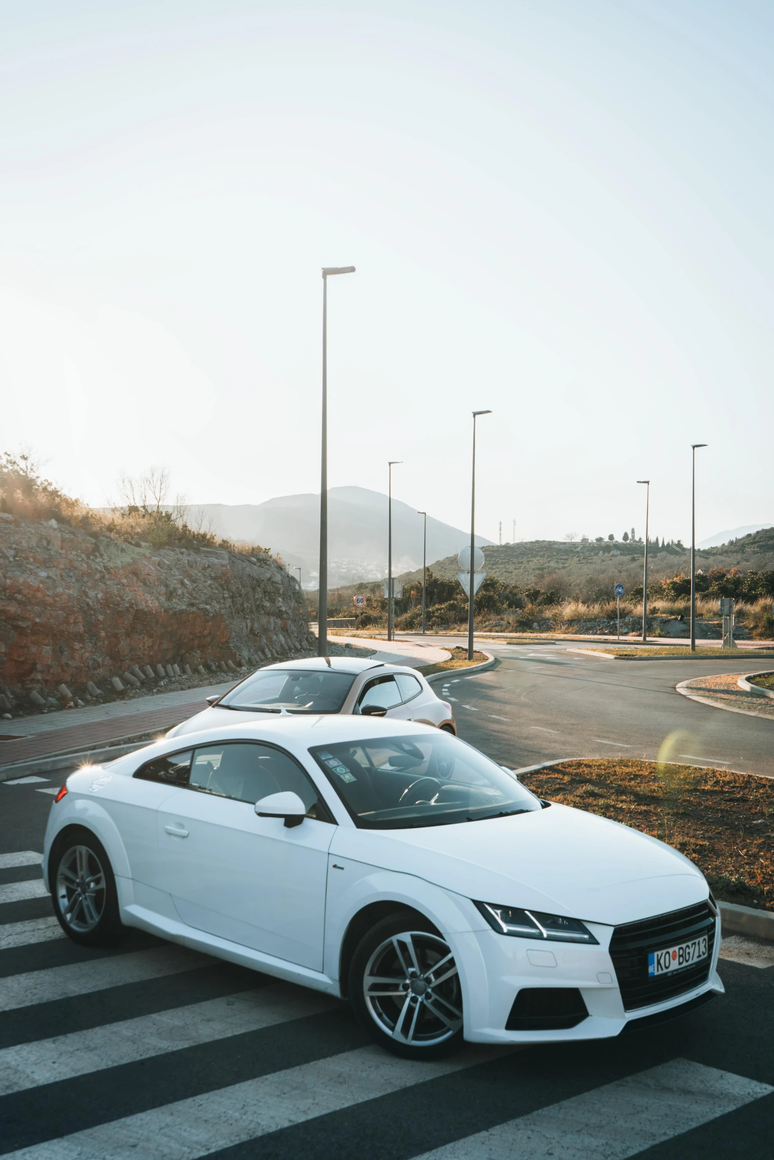 two white car sit parked near each other