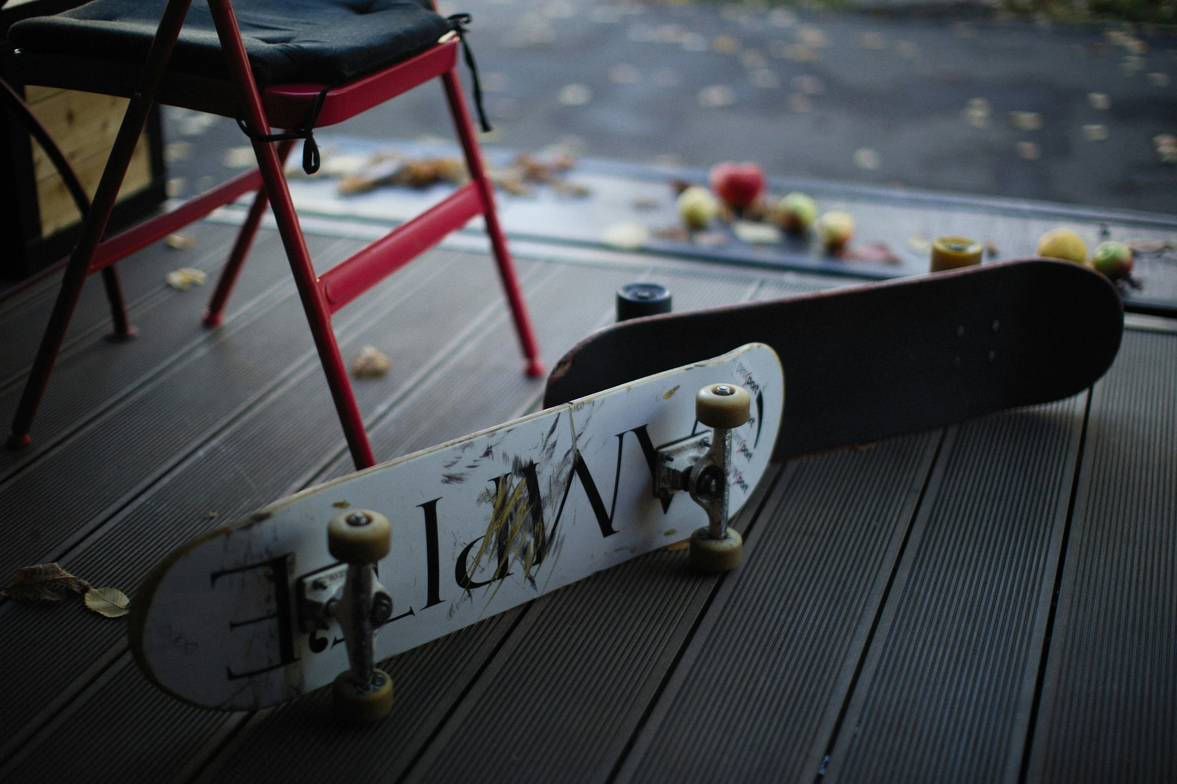 two skateboards that are on a porch