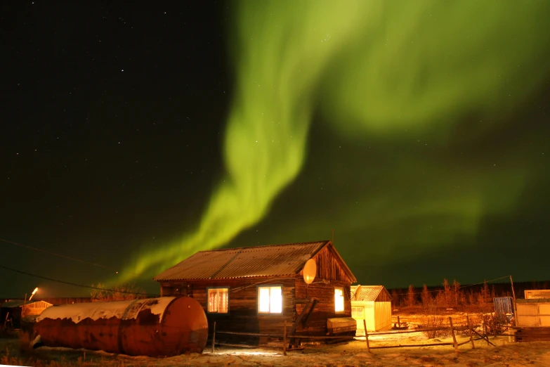 an image of the aurora australe above a small building