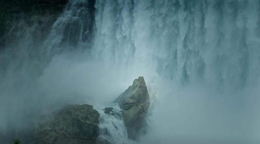 the water gushing out the water and the top of the waterfall